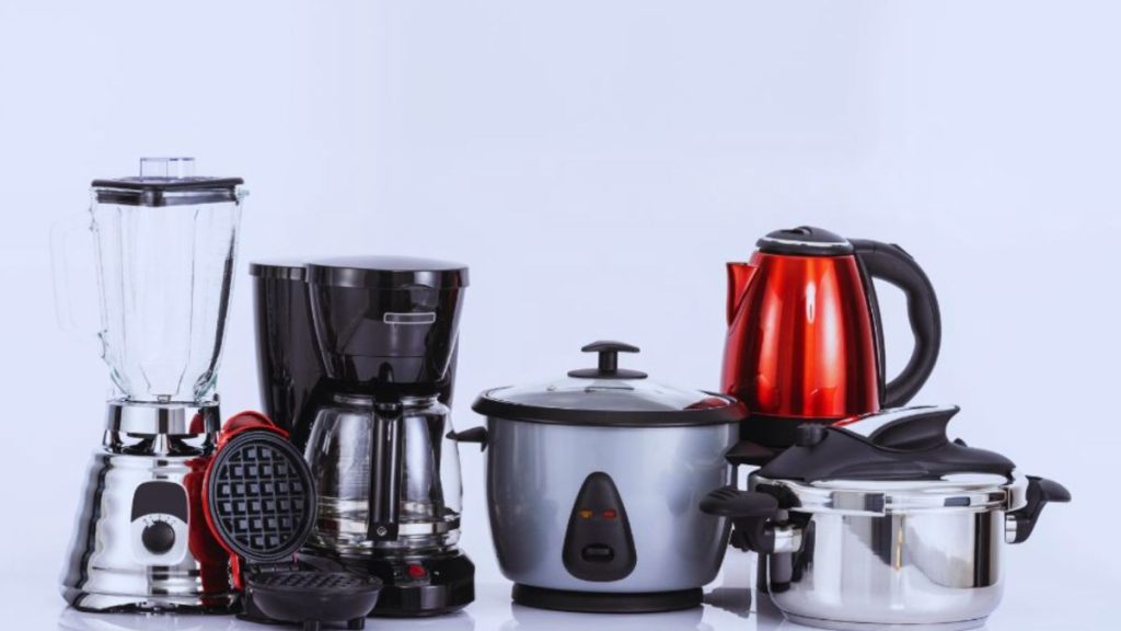 An assortment of kitchen appliances featuring a blender, coffee maker, and juicer neatly positioned on a countertop.