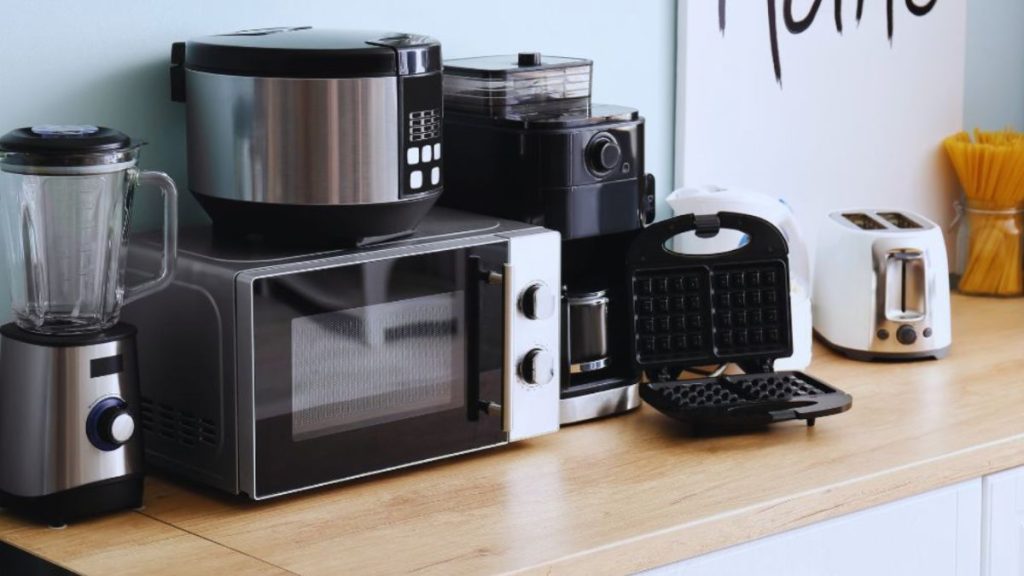 A well-organized kitchen counter displaying a blender, coffee maker, and assorted kitchen appliances.