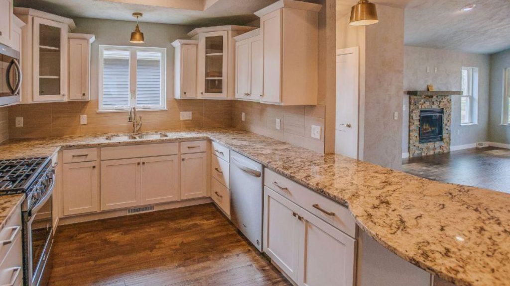 Modern kitchen with white cabinets and granite countertops, emphasizing style and elegance.